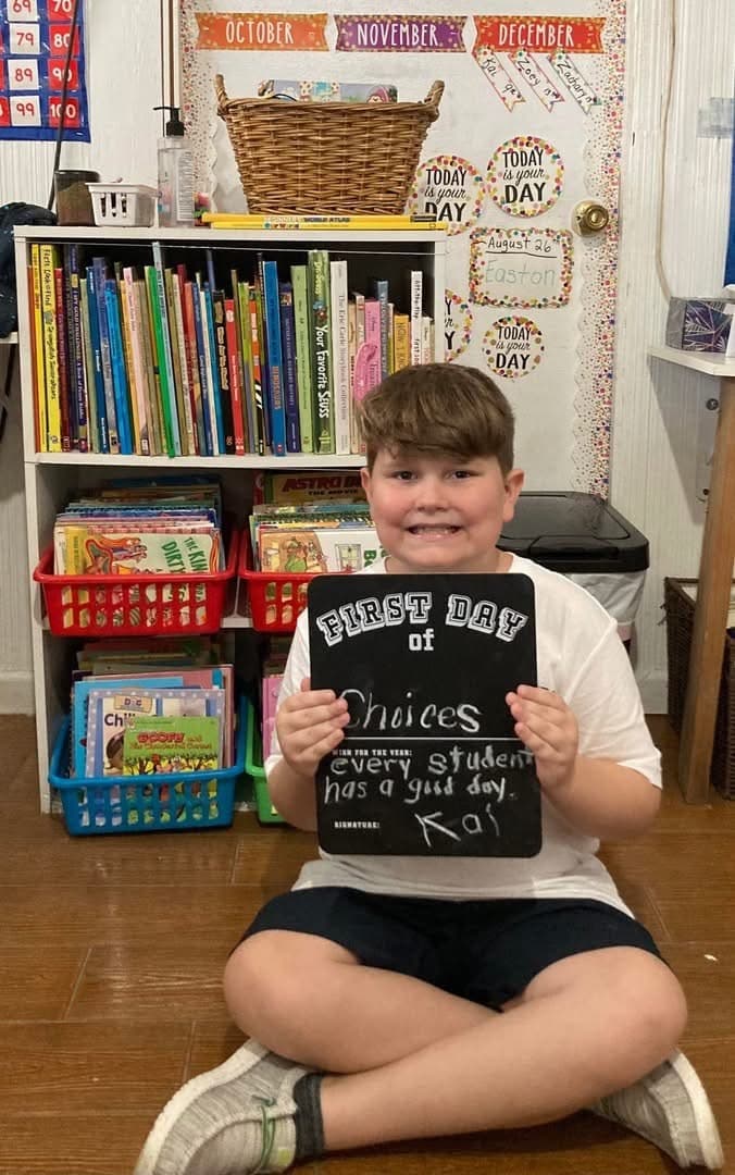 Choices Education Center student holding a first day of school sign